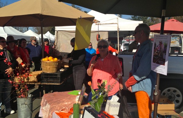 Clark Wolf in his orange pants, Gaye LeBaron in an orange shirt and Middleton Farm Gardens final market stall on Sunday, February 1.