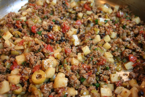 Picadillo often includes olives and potatoes in addition to ground meat and spices